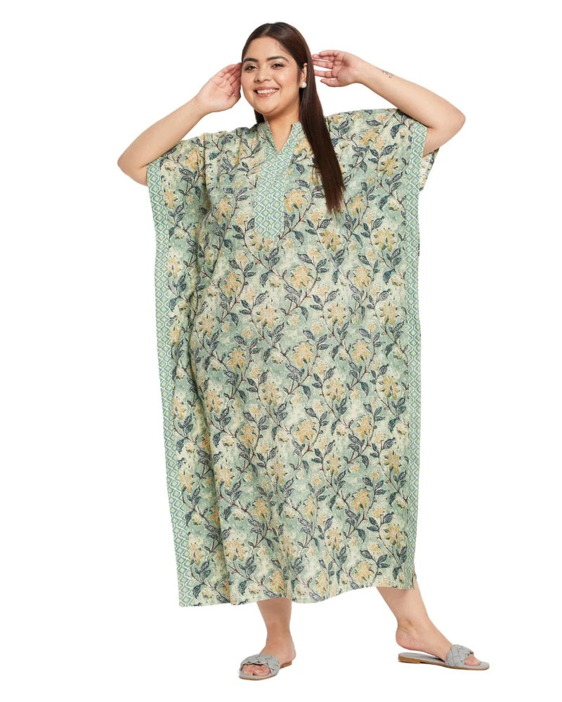 Plus size model in a sage green floral cotton kaftan with a V-neck